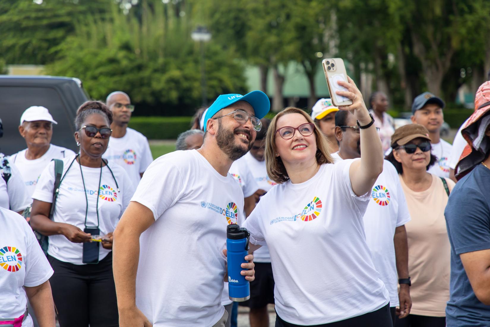 The UN Resident Coordinator in Suriname, Joanna Kazana, stops for a selfie while participating in the SDG Walkathon