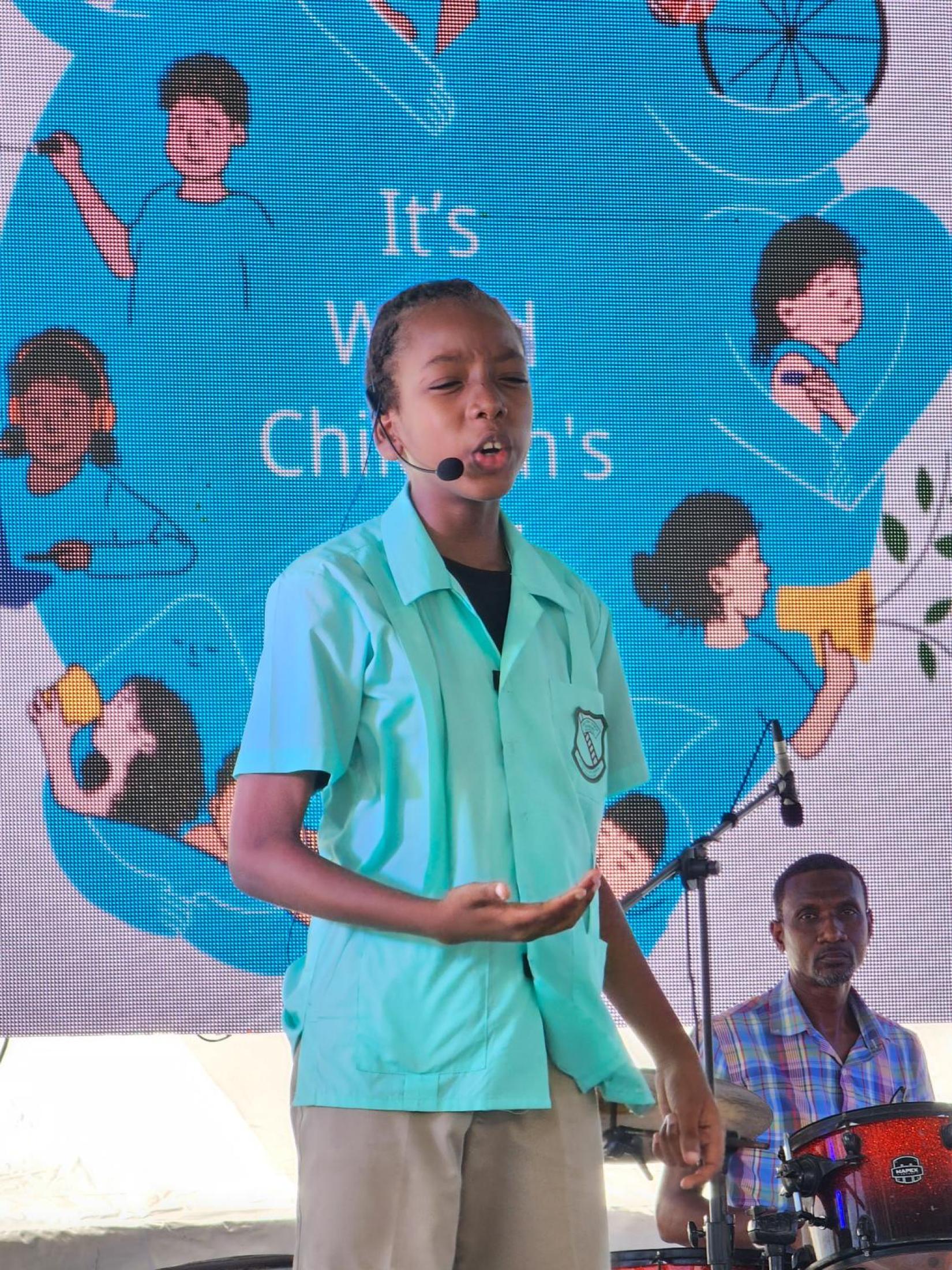 A child addresses an audience at World Children's Day 2023 in Barbados