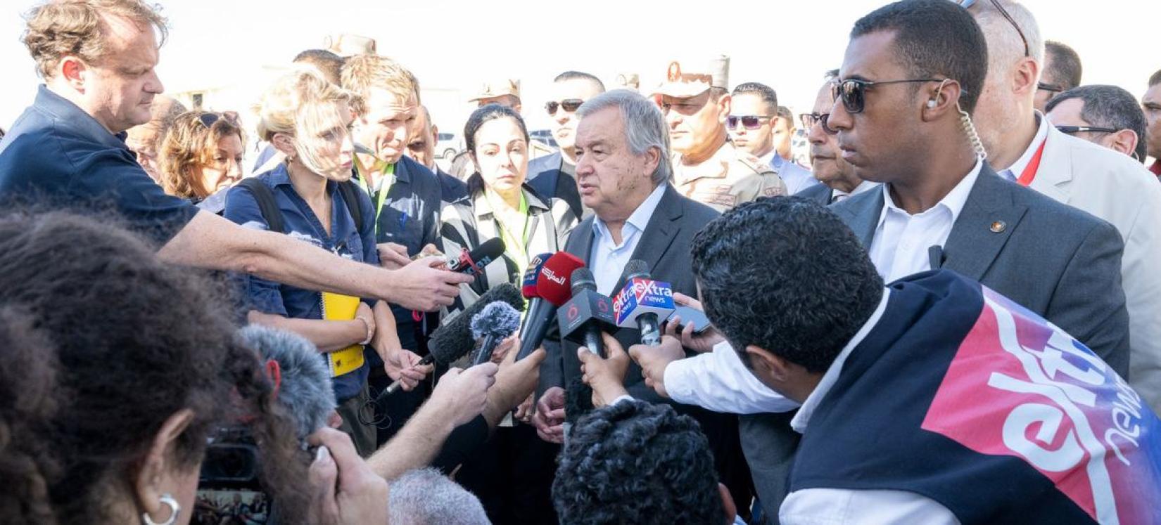 UN Secretary-General António Guterres (centre) answers questions from the media at the Rafah crossing.