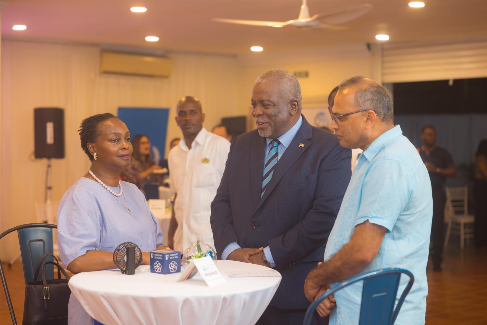  Hon. Brigadier (Ret'd) Mark Phillips, Acting President and Prime Minister of the Cooperative Republic of Guyana (centre) engages with Jean Kamau, UN Resident Coordinator (left) and Hon. Dr. Frank Anthony, Acting Minister of Foreign Trade and International Cooperation and Minister of Health (right).