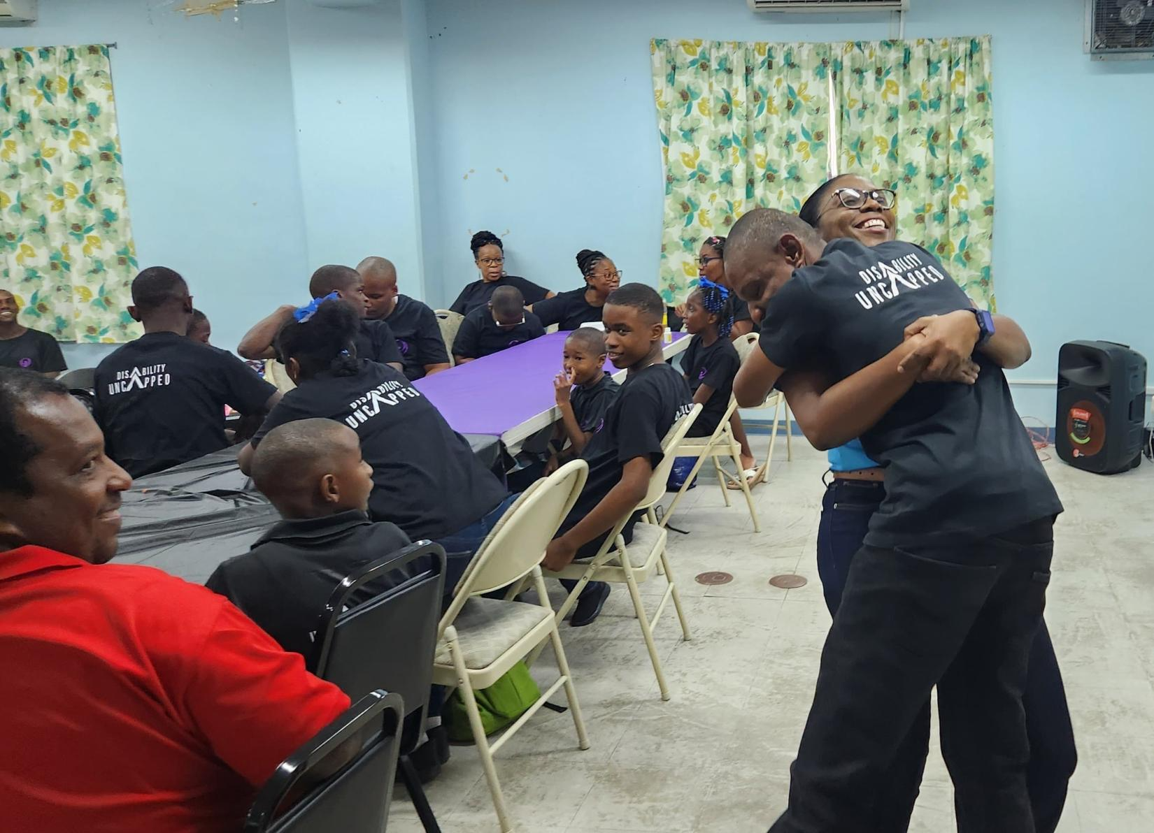  Soufriere Special Education Center student, Mc Lean Felicien sharing a moment of jubilation with UN Country Coordination Officer (Saint Lucia), Dr. Lorraine Nicholas.