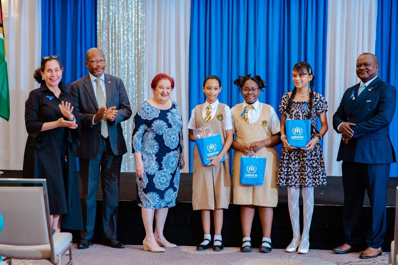 From left to right: Yeşim Oruç, UN Resident Coordinator; Ambassador George Talbot, Director of Multilateral and Global Affairs at the Ministry of Foreign Affairs and International Cooperation; Hon. Gail Teixeira, Minister of Parliamentary Affairs and Governance; three winners of the poetry competition; and Henri Sylvain-Yakara, Head of National Office, UNHCR.