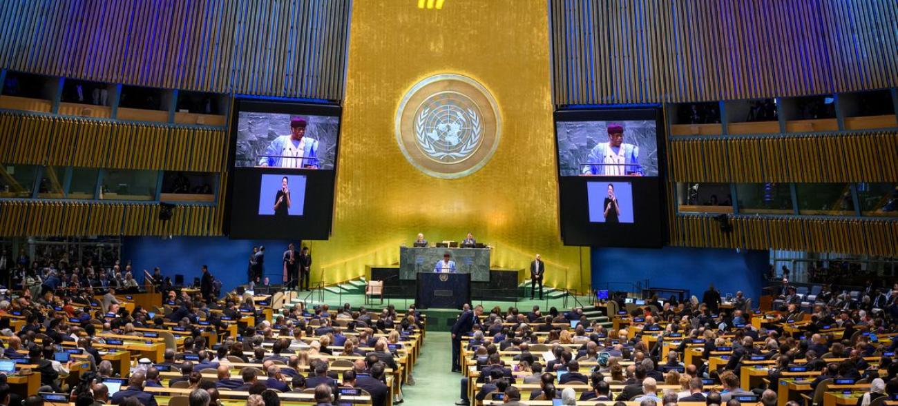 Philemon Yang (at podium and on screens), President of the 79th session of the United Nations General Assembly, addresses the opening of the Summit of the Future on 22 September 2024