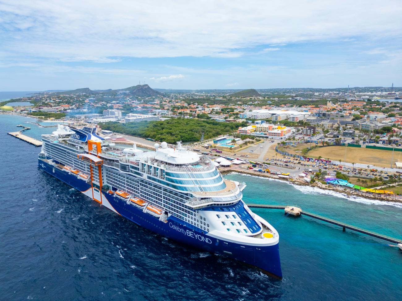 Aerial view of the Celebrity Beyond cruise ship docked in Curaçao’s vibrant port.