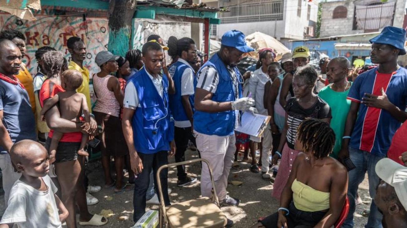 At Place Clercine in Tabarre, Port-au-Prince, Haitians displaced due to gang violence gather for free medical treatment at a mobile clinic of the International Organization for Migration.