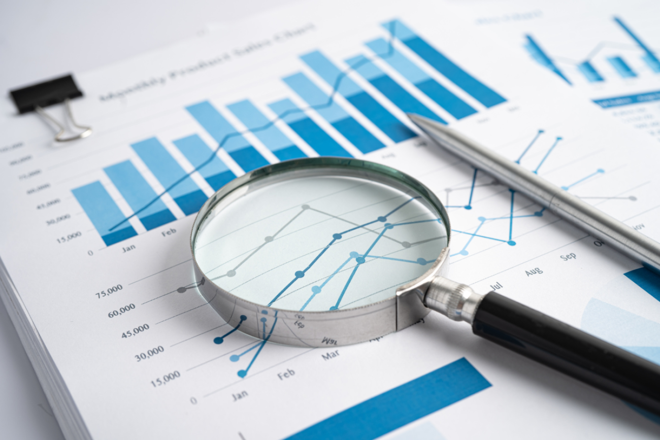 Magnifying Glass on Charts Graphs Paper.