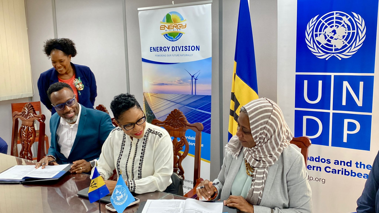 Minister of Energy and Business, Senator Lisa Cummins, witnesses the signing of the SMARTER Project Document by acting Permanent Secretary in the Ministry of Energy and Business, Kevin Hunte and UNDP Resident Representative for Barbados and the Eastern Caribbean, Limya Eltayeb.