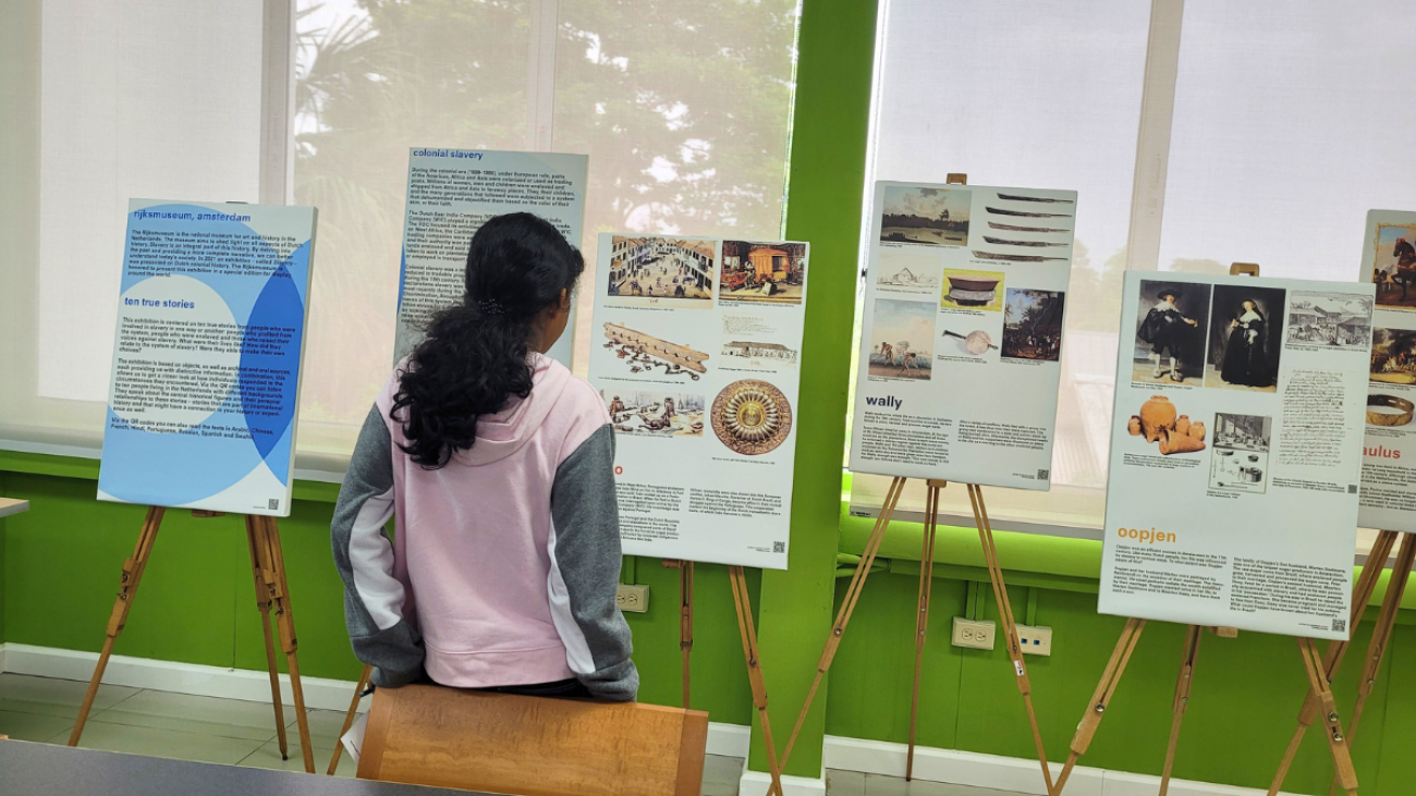 A student in Trinidad and Tobago views the UNIC Caribbean Exhibit on the history of slavery in the Caribbean.