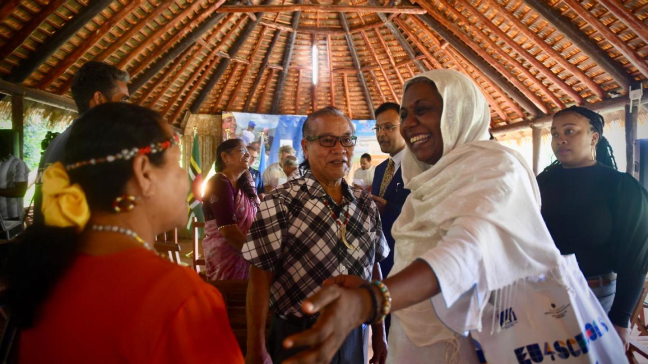 UNDP Resident Representative for Barbados and the Eastern Caribbean, Ms. Limya Eltayeb greets a representative of Dominica’s Kalinago Territory.