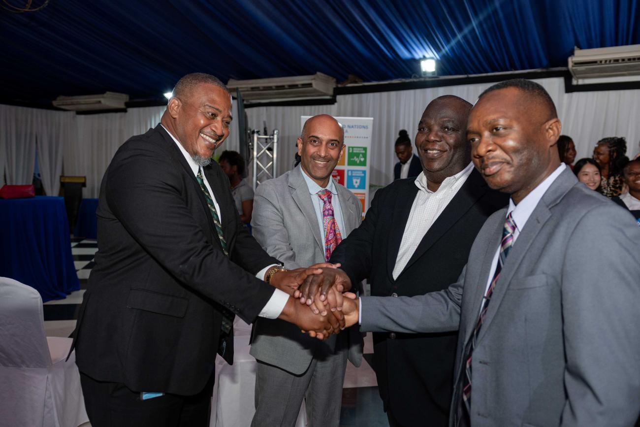 A show of unity in the fight against illicit supply of weapons as demonstrated by from left: Richard Troupe, Director, Safety and Security in Schools in the Ministry of Education, Skills, Youth & Information; UNDP Resident Representative, Dr Kishan Khoday; United Nations Resident Coordinator, Dennis Zulu; and Delroy Simpson, Chief Technical Director, Security Risk Reform and Transformation Policy Division in the Ministry of National Security.