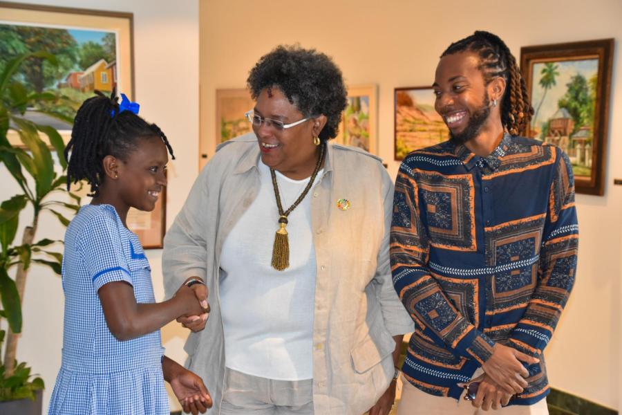 Prime Minister Mottley greets young singer Skyy Dowridge and poet Akeem Chandler-Prescod who brought the audience to their feet following their outstanding performances.