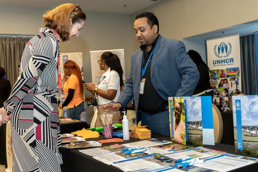 British High Commissioner to T&T, Her Excellency Harriet Cross, speaks with FAO Communications Specialist, Naylan Dwarika, during the Launch of the 2022 Annual Results Report