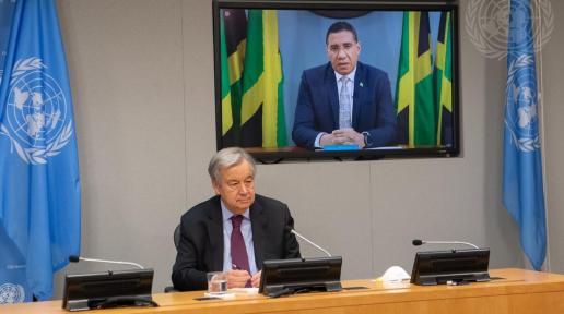 Secretary-General António Guterres (seated) briefs reporters together with Andrew Holness (on screen), Prime Minister of Jamaica, and Justin Trudeau (not pictured), Prime Minister of Canada, on the meeting on "Financing for Development in the Era of COVID-19 and Beyond".