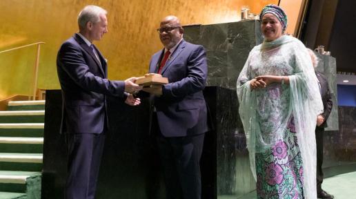 Csaba Kőrösi (left), President of the 77th session of the UN General Assembly, hands the gavel over to Dennis Francis, President of the 78th session.