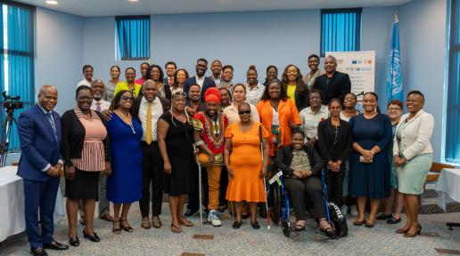 A photo of persons standing together for a photo opportunity with various disabilities. 