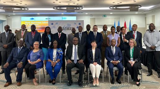 A group photo is shown featuring participatns at a meeting in Saint Lucia where Caribbean States committed to reducing illicit firearms flow across the region