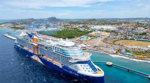 Aerial view of the Celebrity Beyond cruise ship docked in Curaçao’s vibrant port.