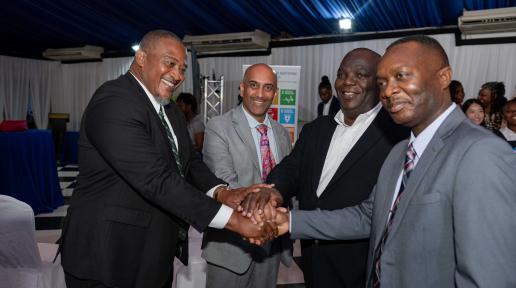 A show of unity in the fight against illicit supply of weapons as demonstrated by from left: Richard Troupe, Director, Safety and Security in Schools in the Ministry of Education, Skills, Youth & Information; UNDP Resident Representative, Dr Kishan Khoday; United Nations Resident Coordinator, Dennis Zulu; and Delroy Simpson, Chief Technical Director, Security Risk Reform and Transformation Policy Division in the Ministry of National Security.